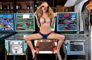 Inked chick Sarah Jessie toys her pussy atop a pinball machine while alone - #1