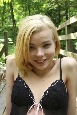 Cute teen amateur Sophia Kitten posing in nude in knee high socks in woods on picsfans.one