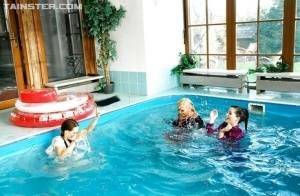 Playful fetish ladies have some fully clothed fun in the pool on picsfans.one