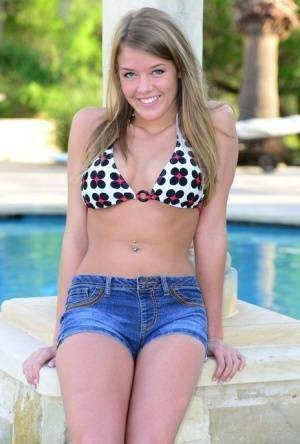 Cute teen Sophia Wood drops her shorts by the pool to toy with a vibrator on picsfans.one